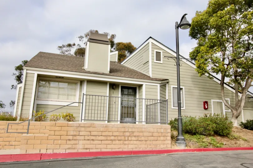 a warm day in the newport terrace wiht house that has top of lights & front of trees, walls