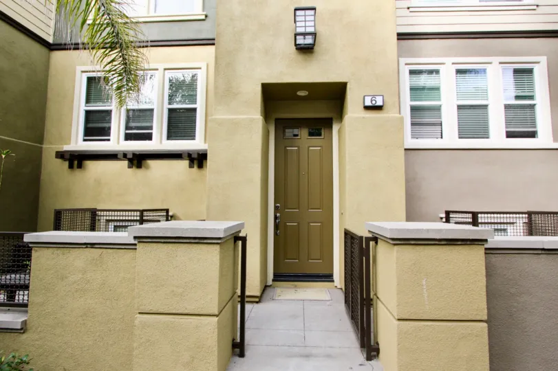 a pleasant day in the one nautical mile with a house that has short compound wall and a steel gate