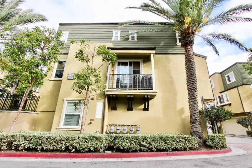 A long red curb sits below the taller One Nautical Mile home in Newport Beach CA