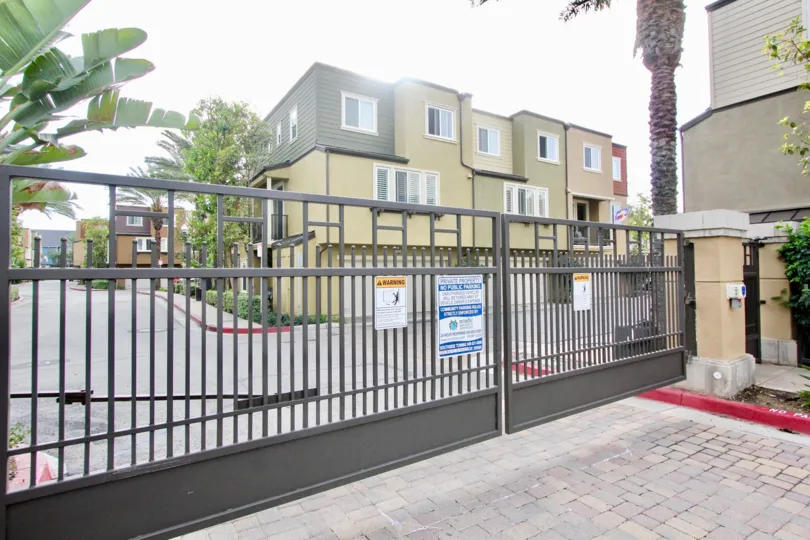 Gated entry and building view at One Nautical Mile in Newport Beach, CA