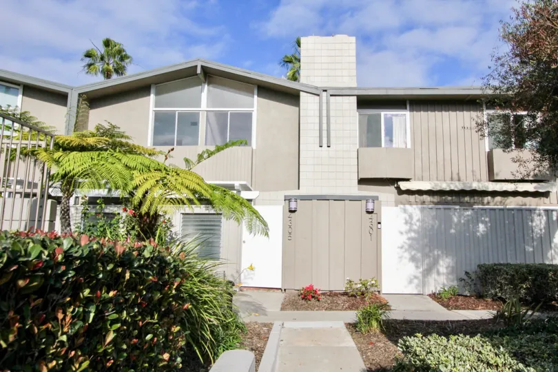 a walkway next to spacious housing at Park Lido in Newport Beach, California