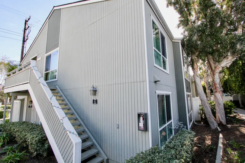A sleek stairway on the side of a two story home at Seawind in Newport Beach CA