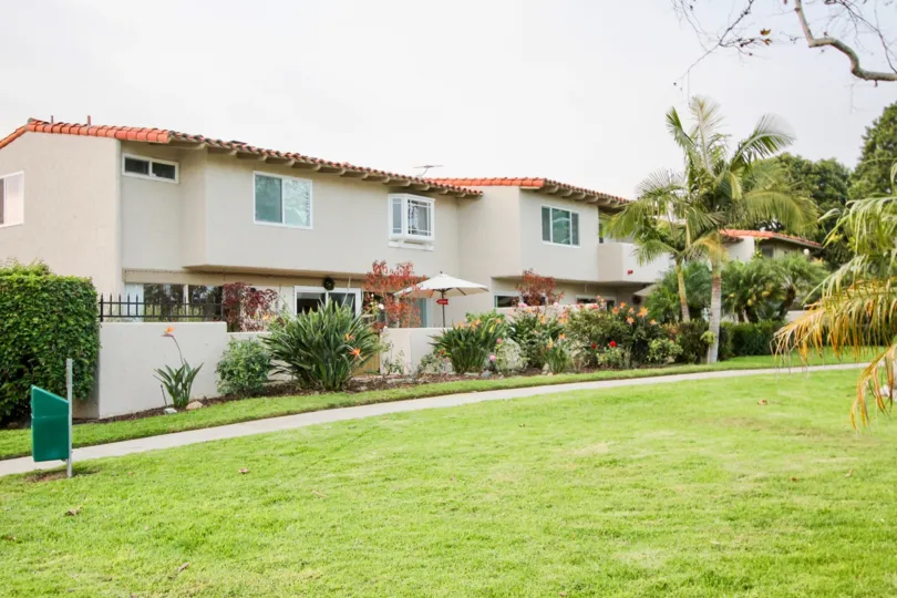 a warm day in the the bluffs with building that has glass windows and garden in front