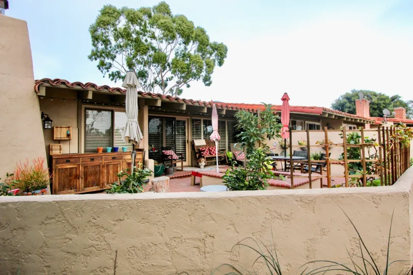 a warm day in the the bluffs with house that has stone around walls and roofless top of tree