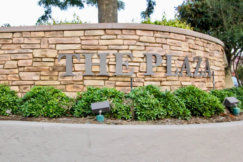 A PARK IN THE The Plaza WITH THE PLAZA WALL, PLANTS, LIGHTS, TREES