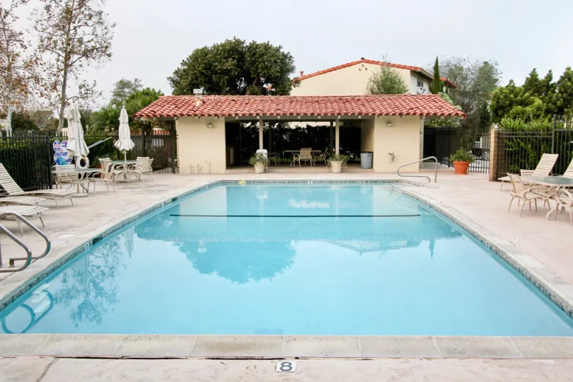 A NICE SWIMMING POOL WITH RELAXING TABLES AND RESTAURANT