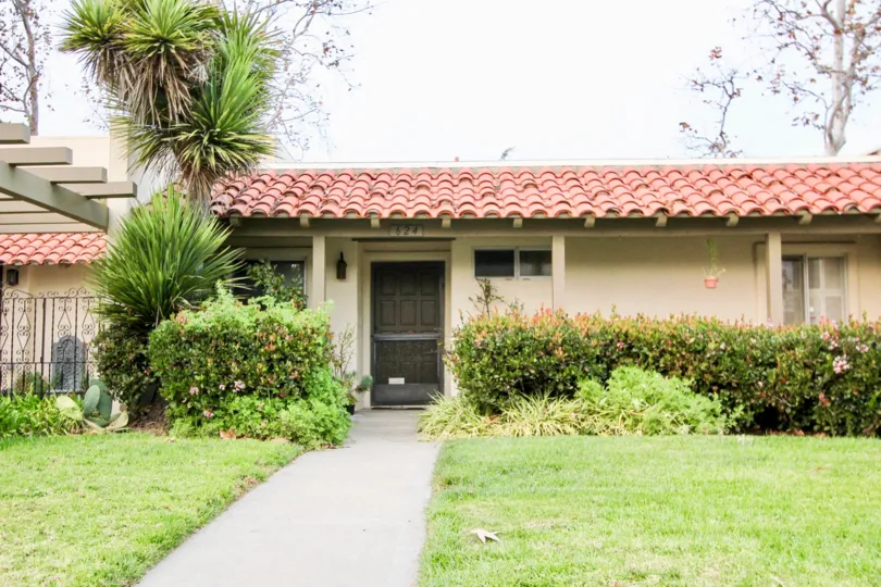 a warm day in the The Plaza with house that has roofless top and garden in front