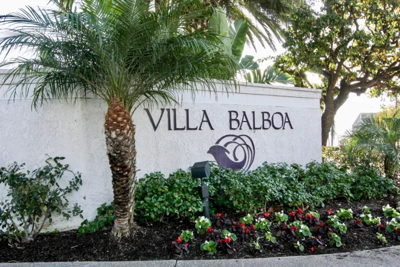 The Wall with Plants and bushes in Villa Balboa mentioned with community name with logo