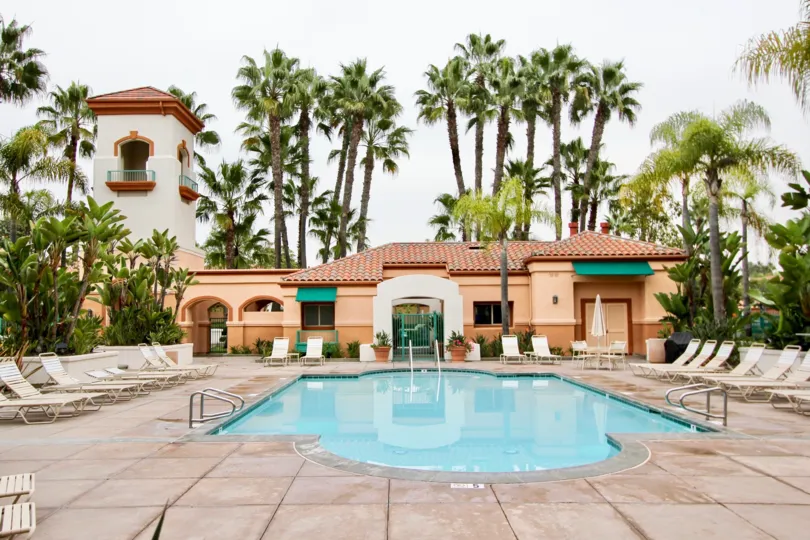a warm day in the villa point with house that has swimming clear water and trees