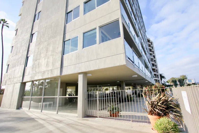 A parking lot sits on the first floor under a condo building of Vista Del Lido