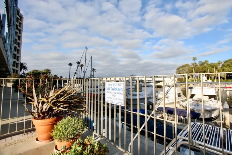 A beautiful day in the Vista Del Lido with a sign board and boats.