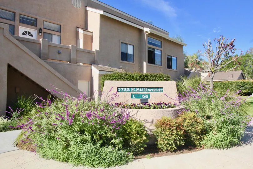 Beautiful garden entrance with bushes, flowers, and three tiers of plants