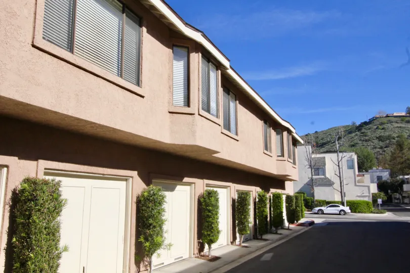 A day in the Canyon Glen with a building and white car.