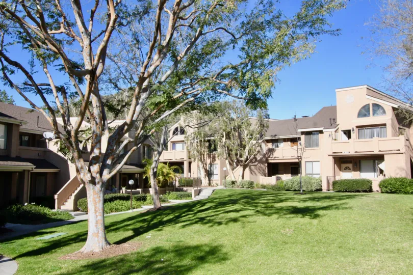 Trees are present at the lawn where is in front to the house in Canyon Glen