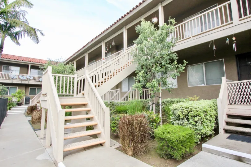 A staircase to the apartments of Casa La Veta with bushes and trees