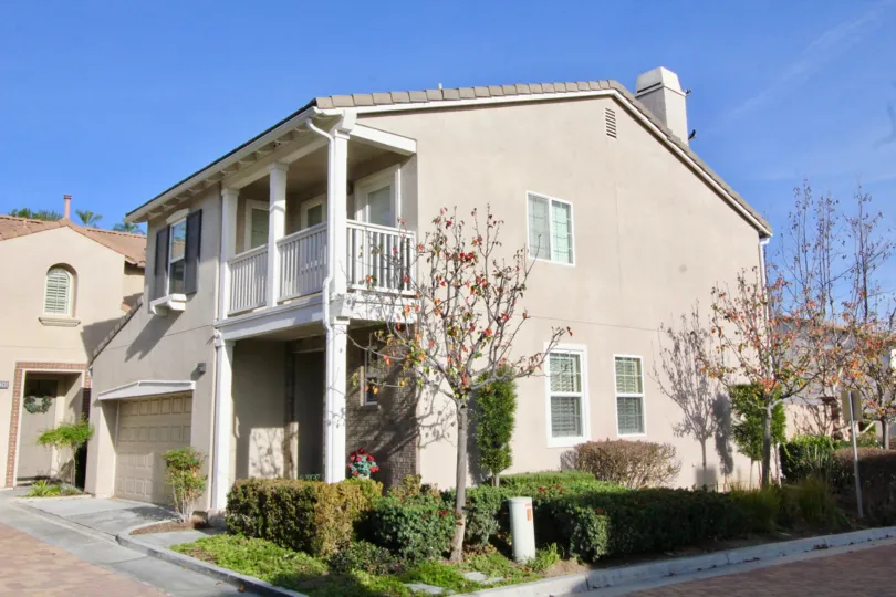 Two story beautul Salmon colored home with trees and bushes in Orange, California