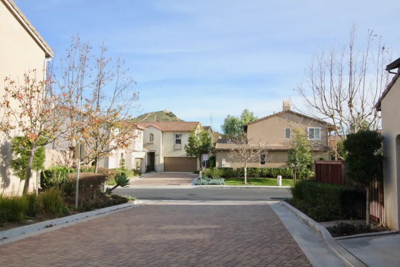 The Cloudy street in the castia community with beautiful homes and clean street with good looking row houses with trees and plants.
