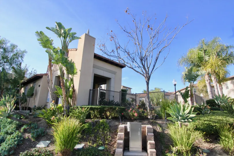 side to the house in Casita has flowers with bushes and trees, plants