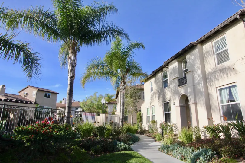 A sidewalk in Casita surrounded by plants and trees on a sunny day