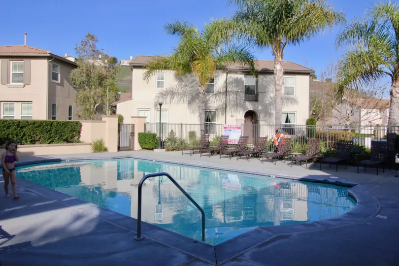 A girl walking along a pool in the Casita community in orange city