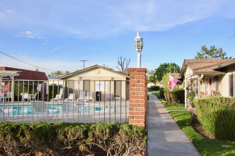 The pool and sidewalk in the Coco Palms community on a sunny day