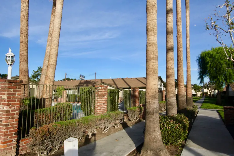 Beautiful garden entrance with bushes, flowers, and three tiers of plants