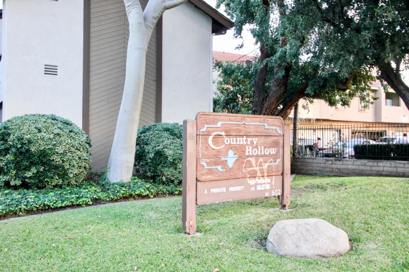 Country Hollow sign in front of the parking lot fence in Orange, California