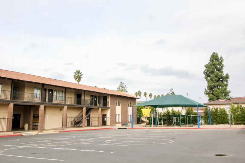 A sunny park in the Criterion community parking lot with a playground