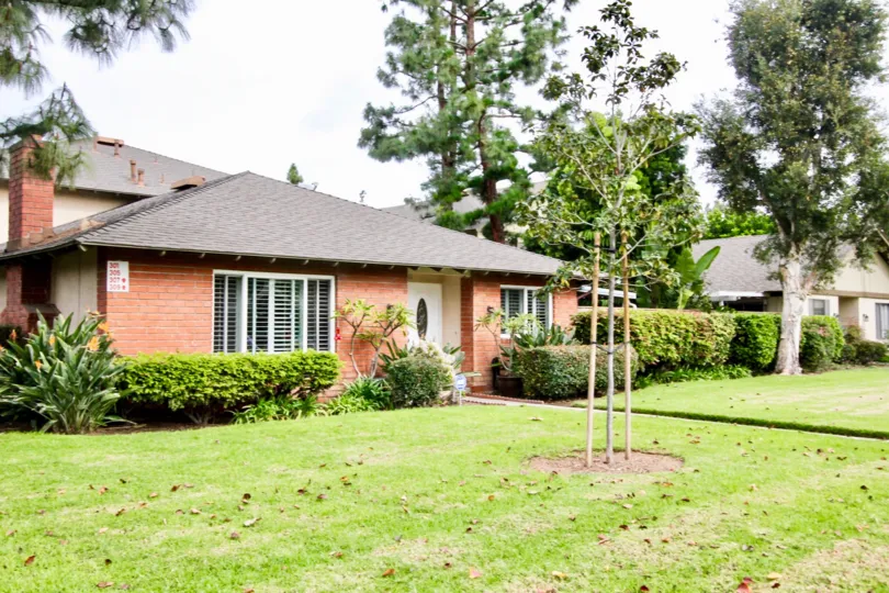 Green lawn gives way to a brick house located in the Criterion community
