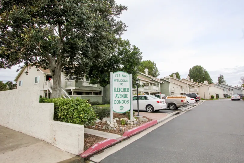some small appartments in the Fletcher Avenue near the rod side with some trees.