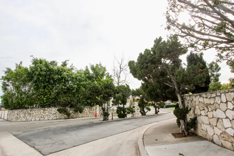 A beautiful rock wall on a street during an overcast day for Golden Circle, Orange California.