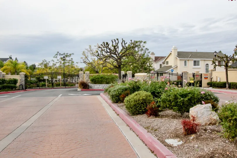 A gated street entrance outside the Huntington community on a cloudy day