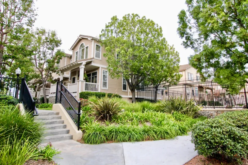 A beautiful home in huntington is look like a oldage home house in the city with lots of trees and plants.