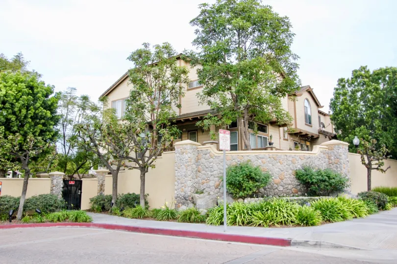Tall beige house with trees in Huntington, Orange California