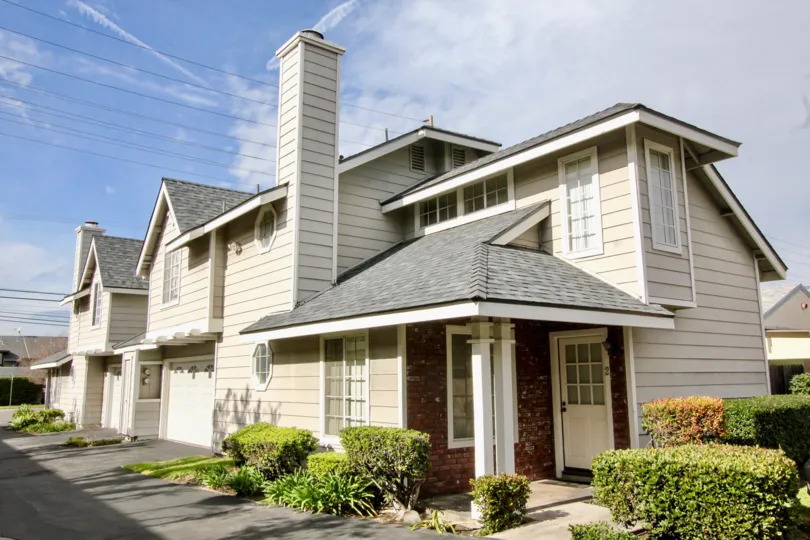 In orange Creek community, a villa with cutting bushes and light lamps near the door of entrance