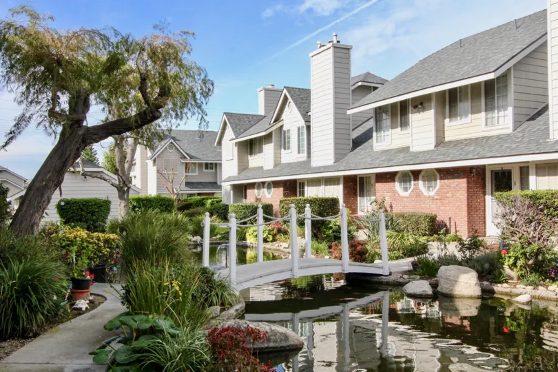 Stream in Orange Creek with a sidewalk and bridge on top of it.