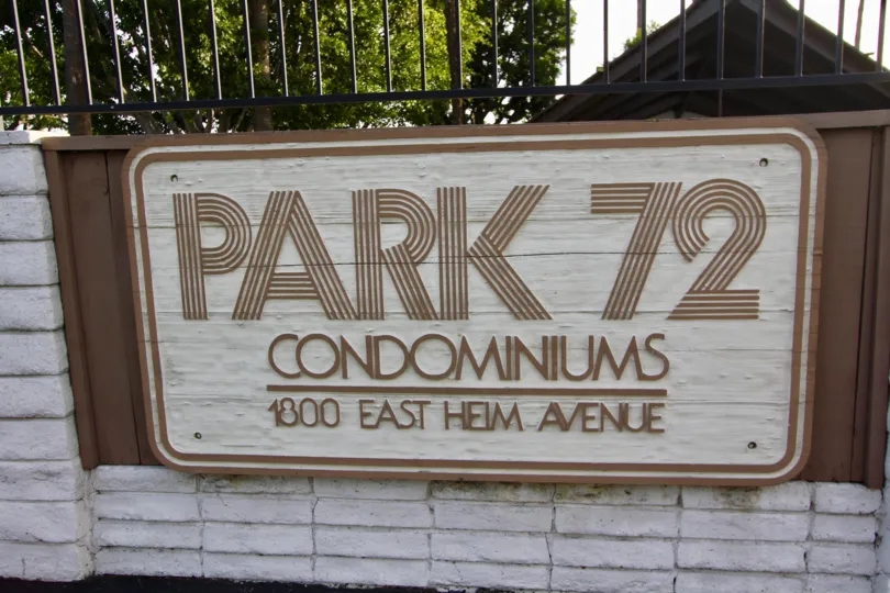 A clear day in the Park 72 in front of a signage on the wall.