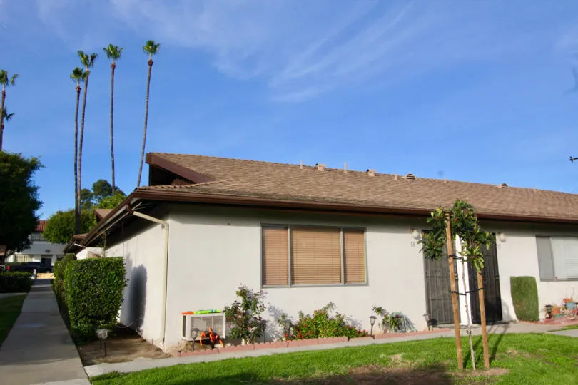 A beautiful home in Park 72 framed by palm trees in Orange, California.