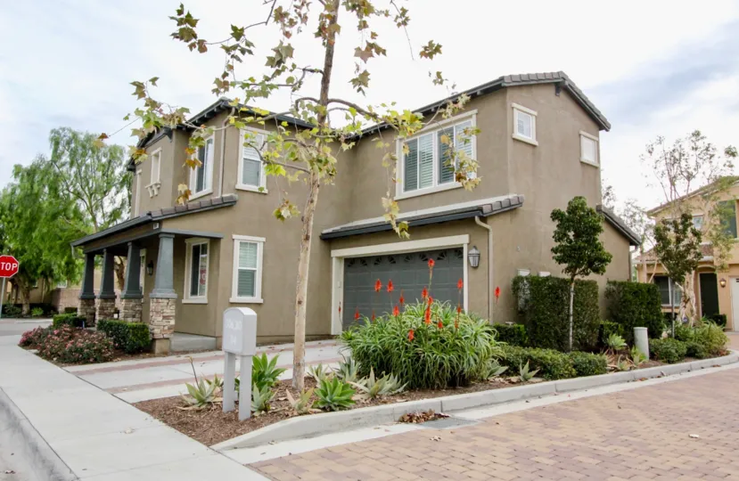 A house in the Riverbend community with trees and bushes
