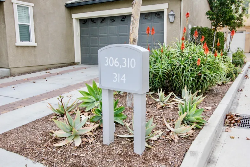 the home in riverbend with yard, trees and plants with beautiful flowers and peaceful place.