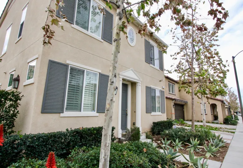 A two storyed building at a corner with a small garden in the Riverbend community