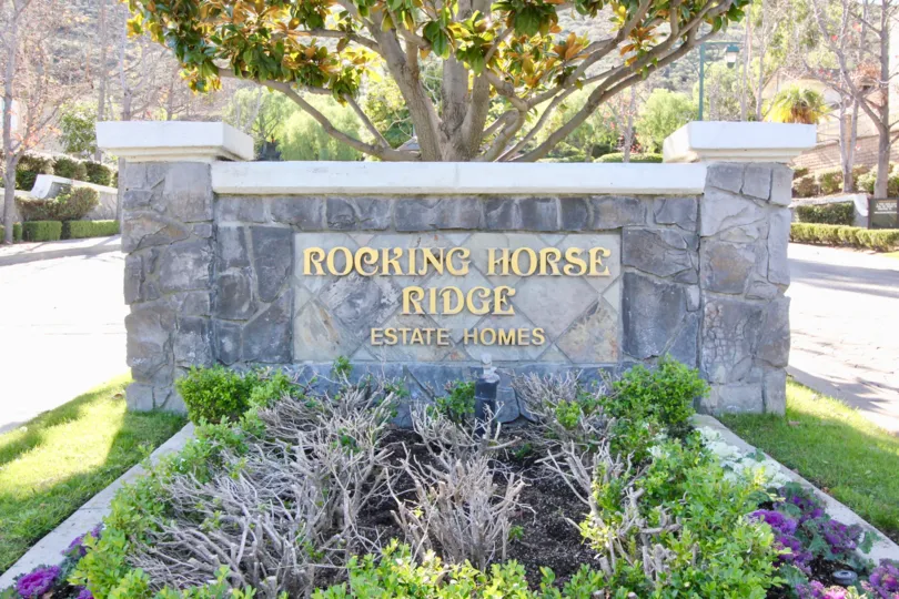 Beautiful garden entrance with bushes, flowers, and three tiers of plants