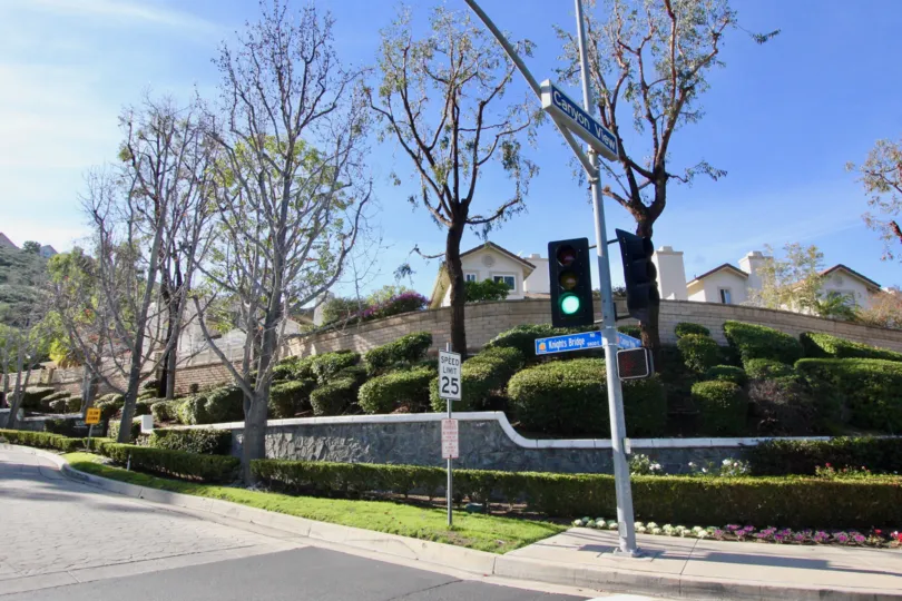 A sunny day outside the Rocking Horse Ridge community with trees and bushes