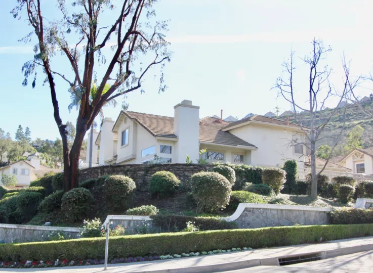 Beautiful garden entrance with bushes, flowers, and three tiers of plants