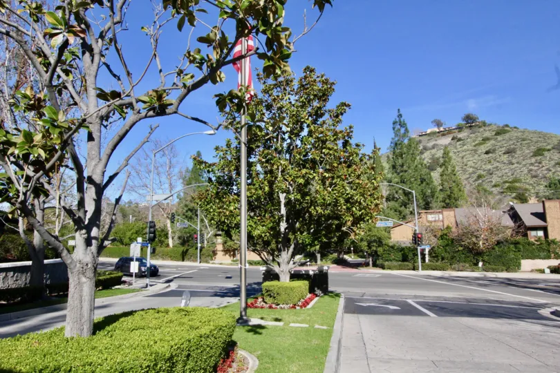 Beautiful garden entrance with bushes, flowers, and three tiers of plants