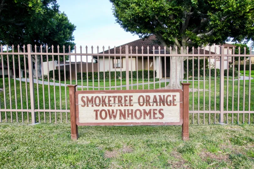The sign to the Smoketree Orange Townhomes community in front of the lawn