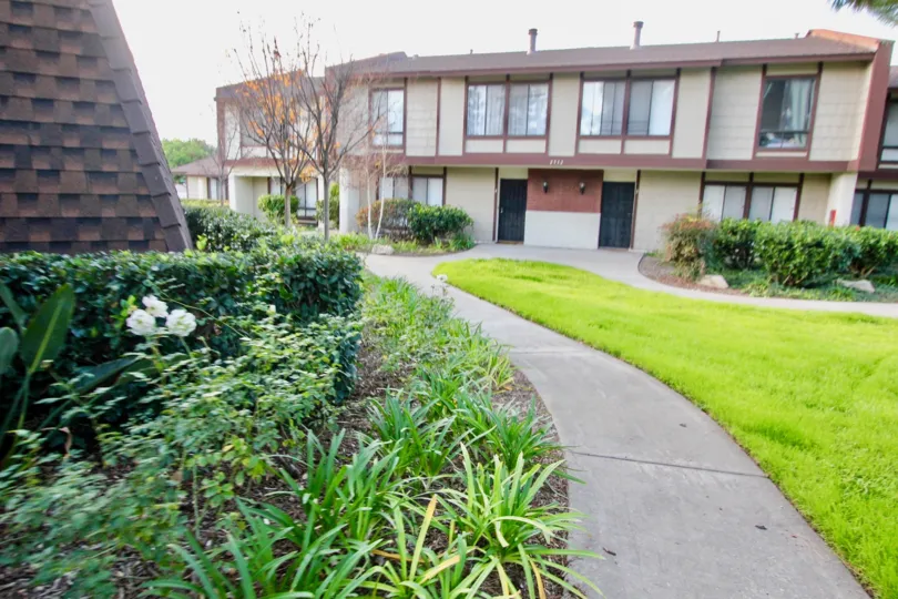 A day at Smoketree Orange Townhomes with a beautiful lawn and old building.