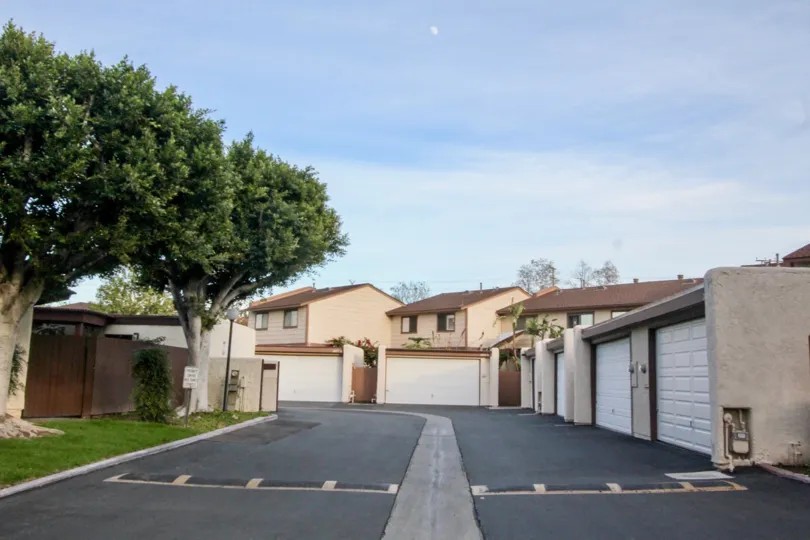 A street in the Smoketree Orange Townhomes community with road bumps on a sunny day