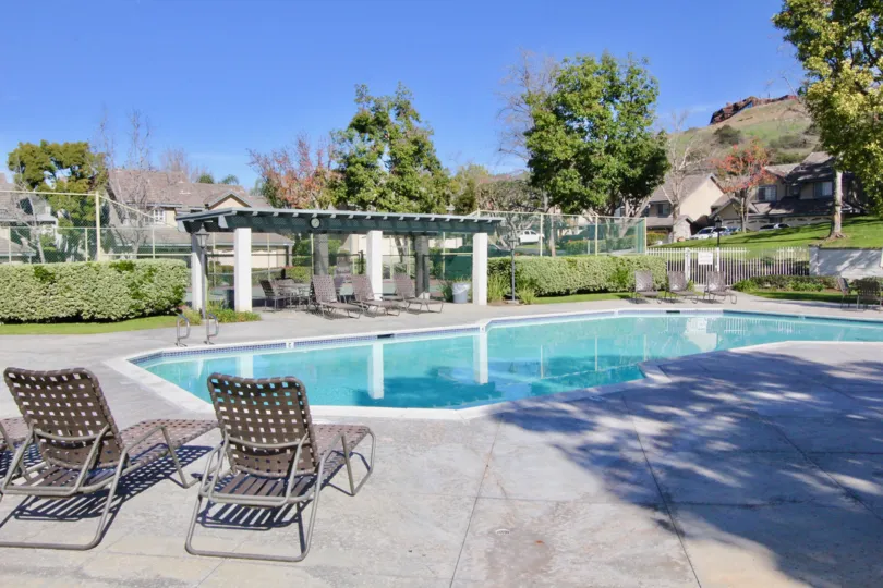 Sun shines on the pool and patio in the Stonehenge community