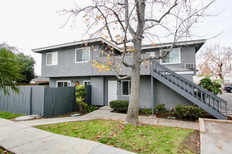 Gray house with a grey wooden fence at the Stoneybrook Villas
